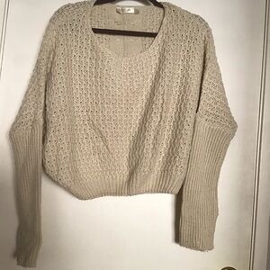 Women’s sweater, knitted cream color, loose, fit with tight sleeves.